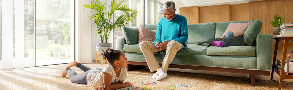 Grandfather and granddaughter doing a puzzle 